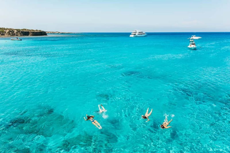 Paphos: Blue Lagoon Boat Adventure with Bus Transfer - Wine, fruit, and the ride back