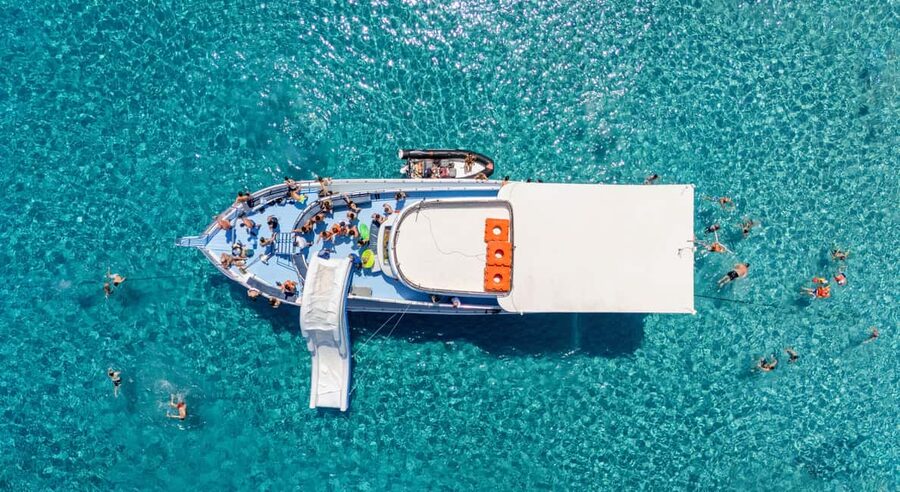 Paphos Blue Lagoon Cruise: Slide, Music & Hotel Transfer - Boarding the boat at Latchi